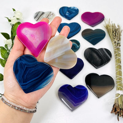 multi colored agate hearts in hand 