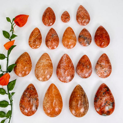 multiple orchid calcite drops displayed to show the differences in the color shades and shape differences 