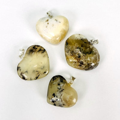 close up of the details on the dendrite opal heart pendants 
