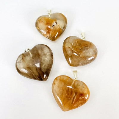 close up of the details on the caramel amphibole heart pendants 