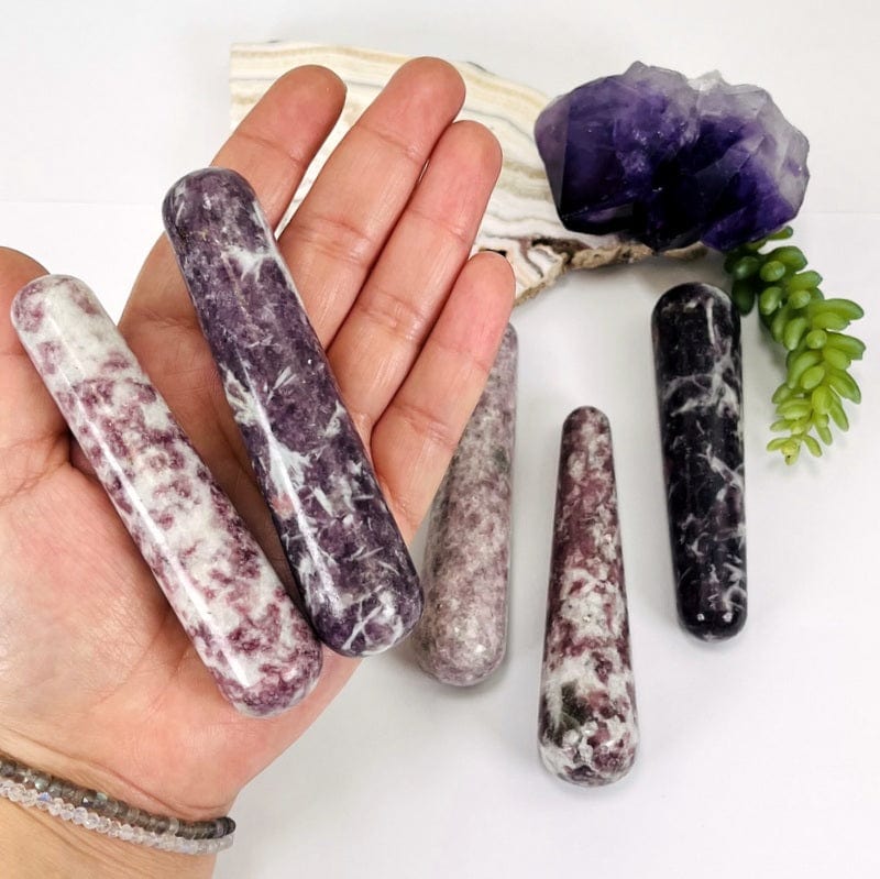 lepidolite massage wands in hand for size reference 