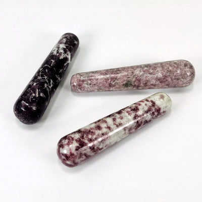side shot of lepidolite massage wands displaying the different thicknesses 