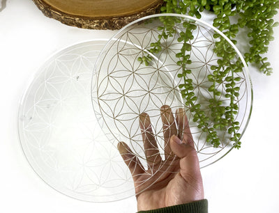 Two Crystal Grid Flower of Life Acrylic Grid held by hand for size comparison