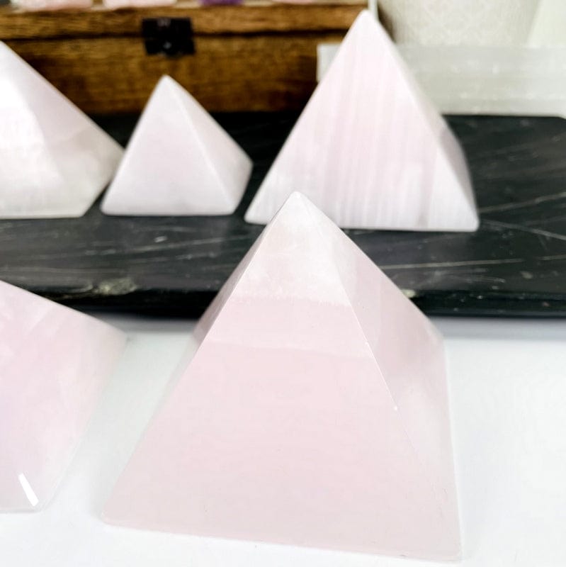 close up of the patterns on these pink calcite pyramids 