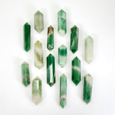 multiple green and white quartz double terminated points showing different sizes and patterns
