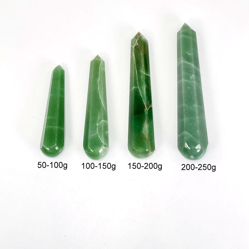 green quartz polished massage points next to weight in grams 