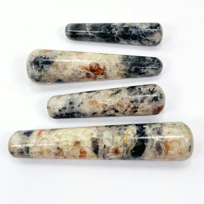 multiple iolite and sunstone massage wands displaying the different sizes and color patterns 