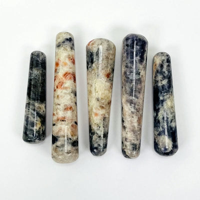 multiple iolite and sunstone massage wands displaying the different sizes and color patterns