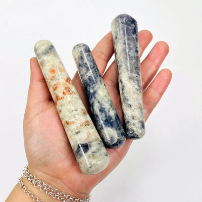 iolite and sunstone massage wands in hand for size reference 