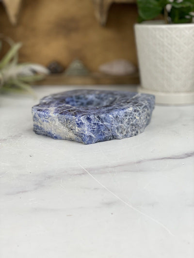 angled view of sodalite polished soap dish laying flat for thickness