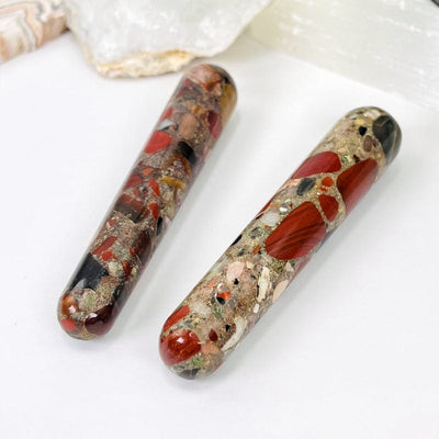 close up of the red jasper massage wands showing the different colors in the stone. it has pops of reds, tans, black and browns. 