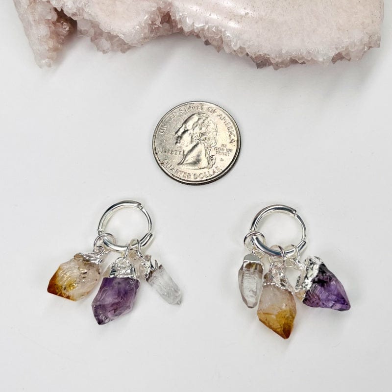 earrings next to a quarter for size reference 