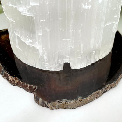 close up of one selenite xxl lampstand up with carved cable hole showing
