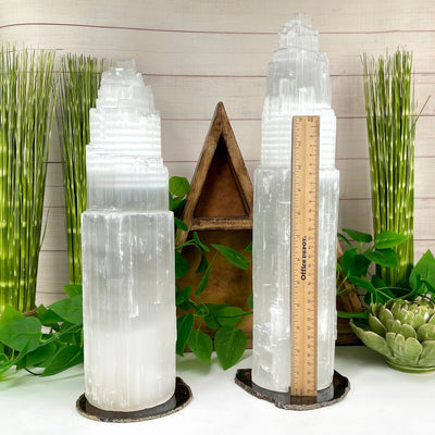 two selenite xxl lamps on display in front of backdrop with horizontal ruler for height reference