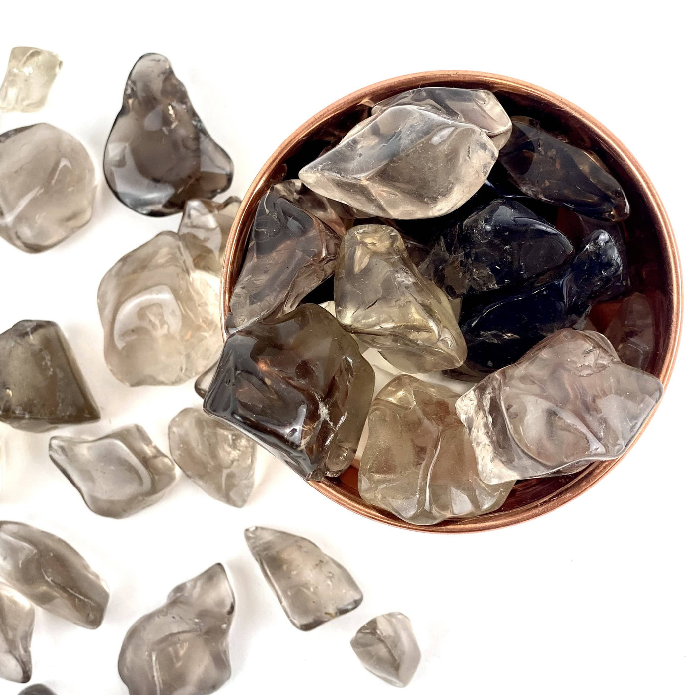 Smokey Quartz Small Tumbled Stones in a bowl and spread on a table