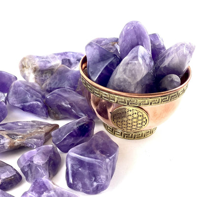 Side angle view 1/2 lb Amethyst Tumbled Stones in bowl (bowl not included)