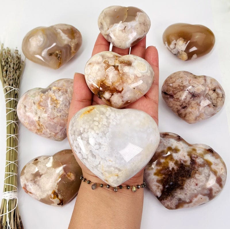 flower agate hearts in hand for size reference 