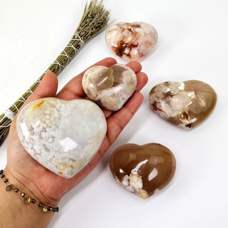 flower agate hearts in hand for size reference 