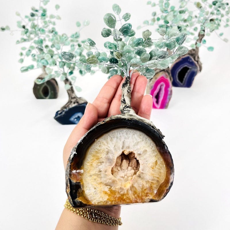 geode tree with tumbled green quartz in hand displaying size  