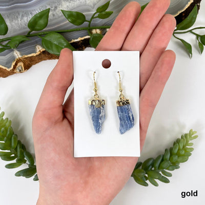 gold blue kyanite earrings in hand for size and finish reference 