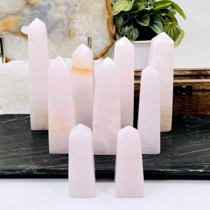 multiple pink calcite obelisk displaying the different possible sizes 