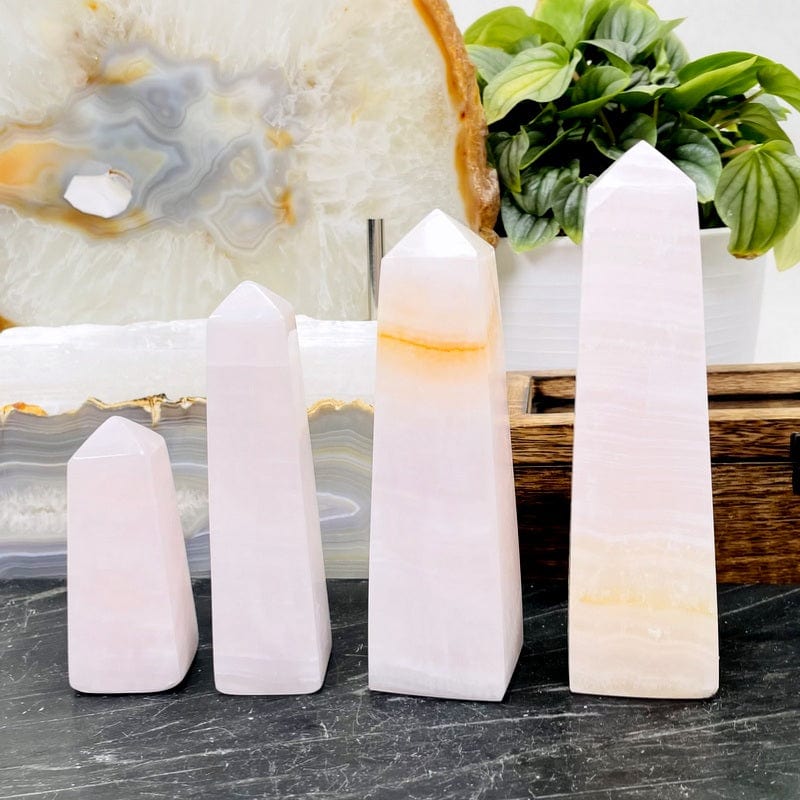 multiple pink calcite obelisk showing the different sizes and possible patterns 