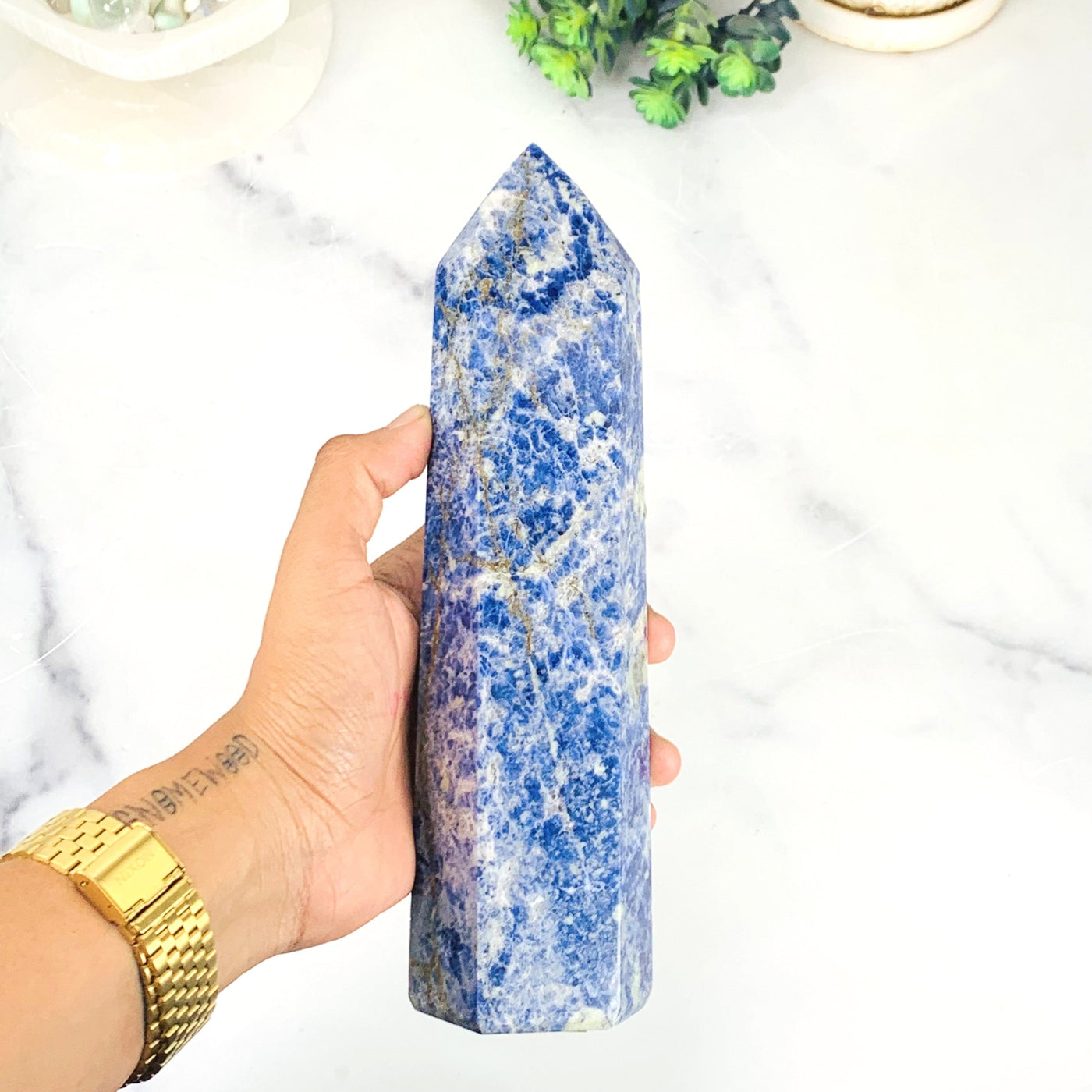 Frontside of the Sodalite Polished Tower Point on hand 