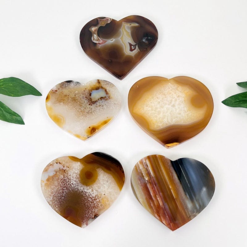 multiple natural agate hearts displayed on white background showing the different types of variations