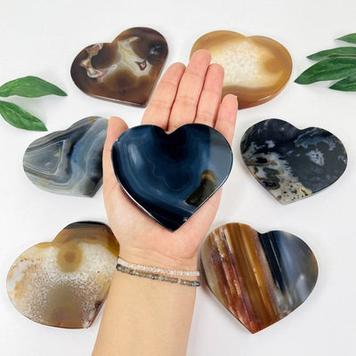 heart shaped agate in hand for size reference 