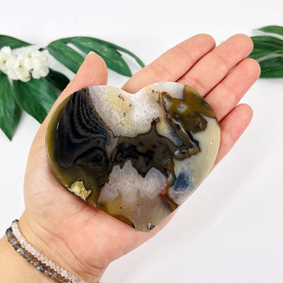 natural agate heart in hand to show details and for size reference 