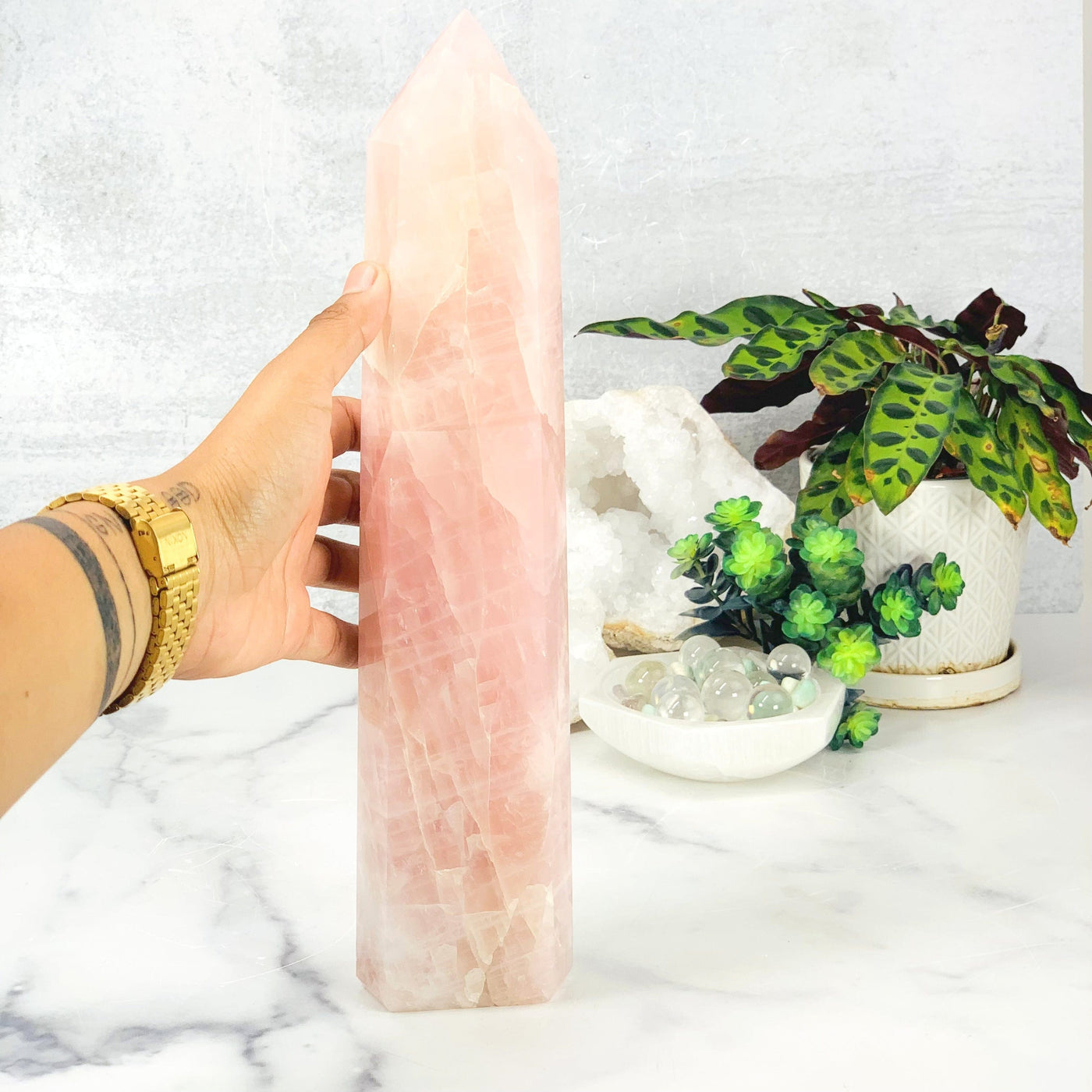 Hand comparing size to the Rose Quartz Polished Tower