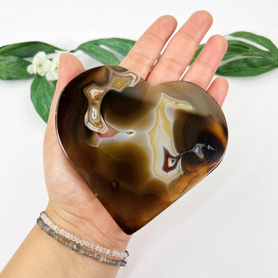 natural agate heart in hand to show details and for size reference
