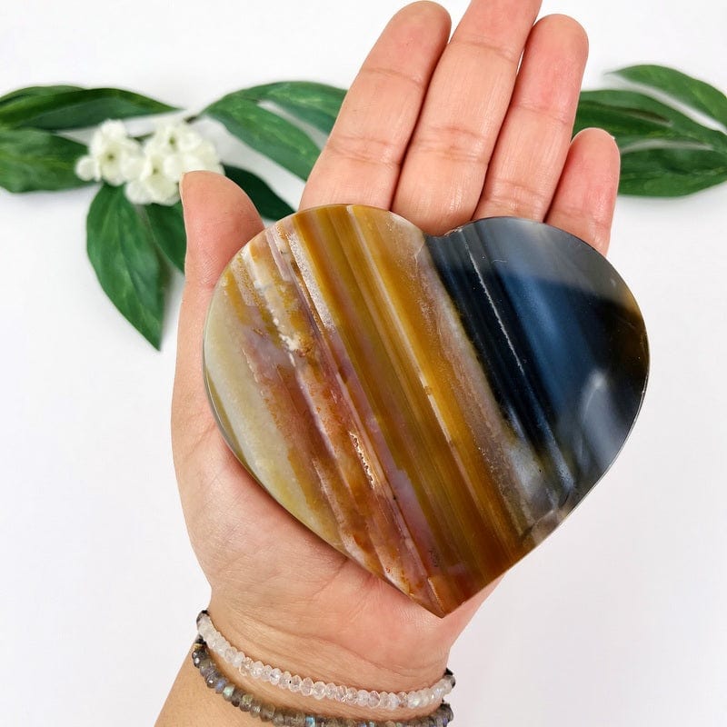 natural agate heart in hand to show details and for size reference