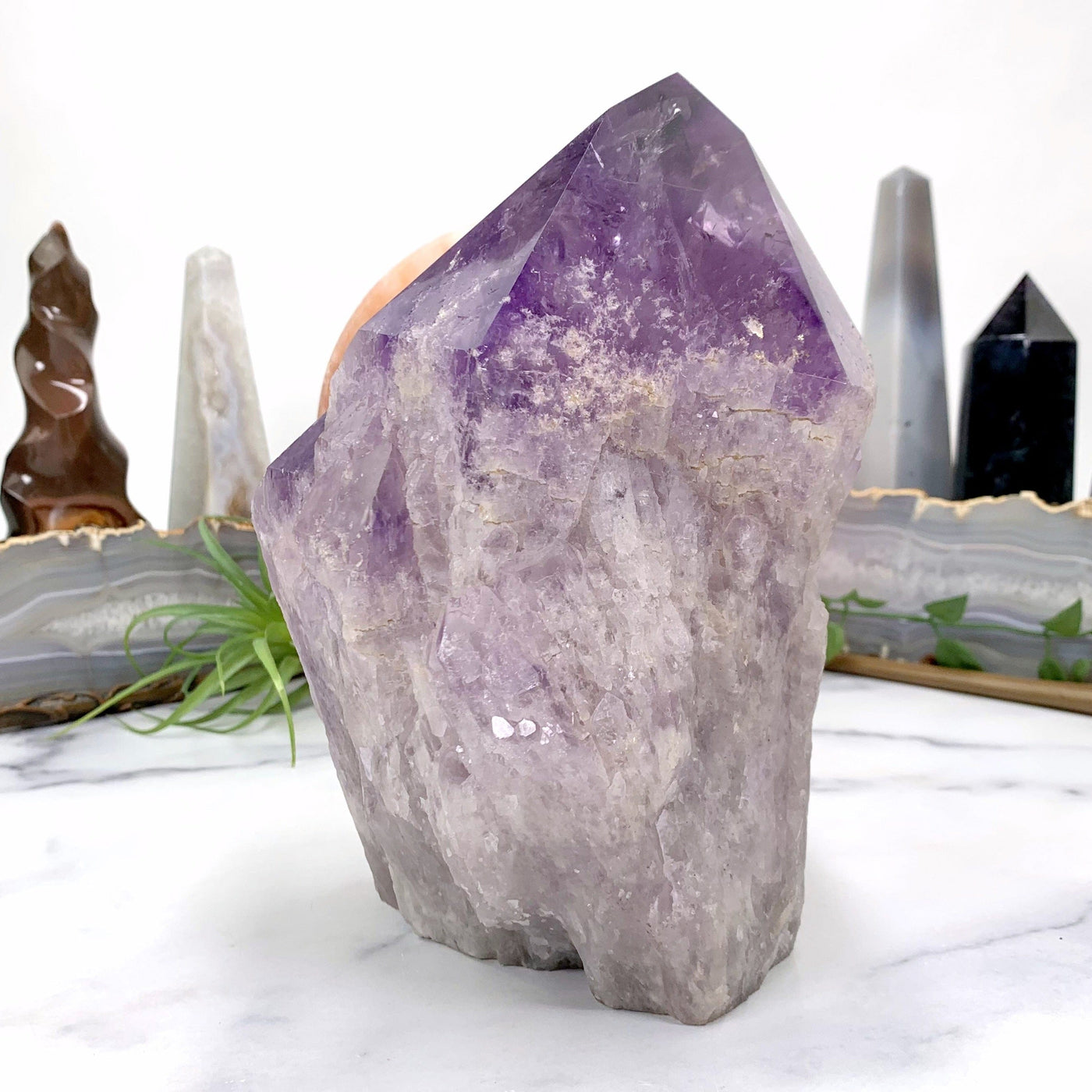 side view of amethyst point on marble background