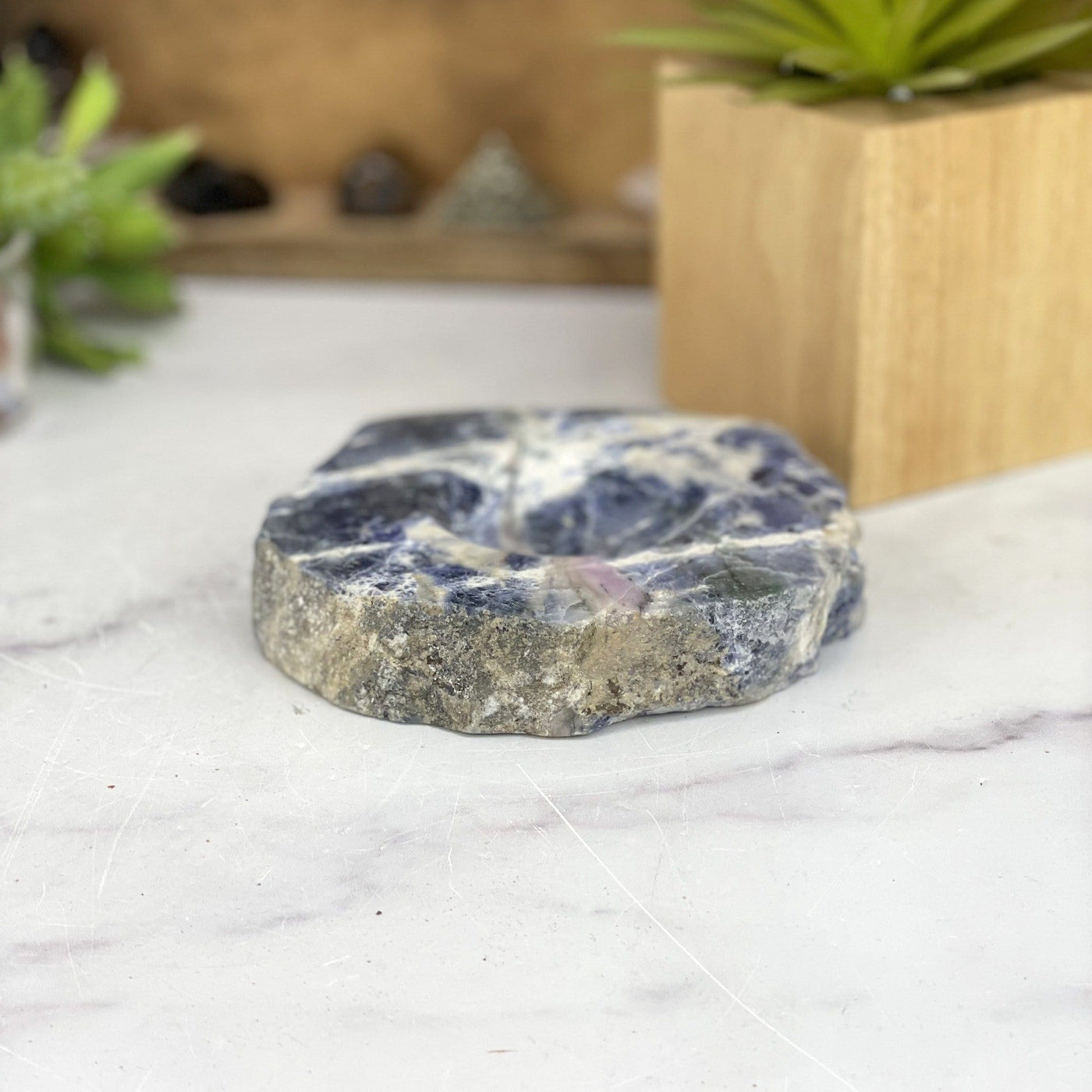 angled view of sodalite polished soap dish laying flat for thickness