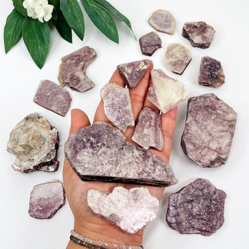 lepidolite with mica slabs in hand for size reference 