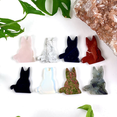 8 crystal cat figurines on a white background