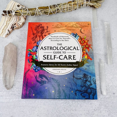 front cover of the astrological guide to self-care by constance stellas