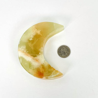 green onyx moon next to a quarter
