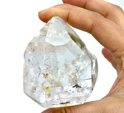Lodolite Crystal Quartz Enhydro held alone in hand.