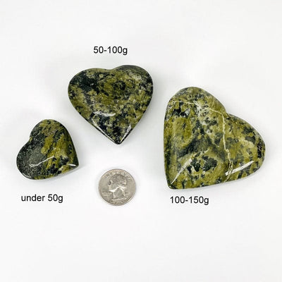 jadeite hearts next to a quarter for size reference and the weight in grams 