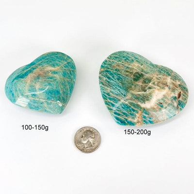 polished amazonite heart next to a quarter for size reference and the weight in grams 