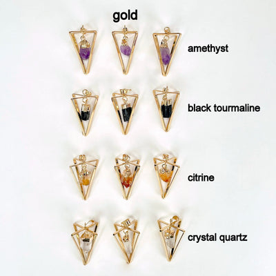 overhead view of all gold dangle stone point pendulum pendant options on white background for possible variations