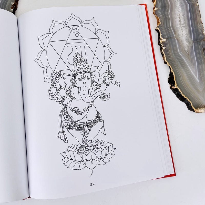 one page of the coloring book showing a chakra symbol that's ready to be colored