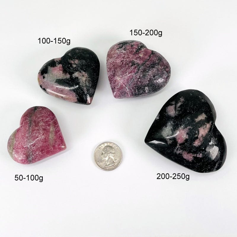 rhodonite hearts next to a quarter for size reference and the weight in grams 