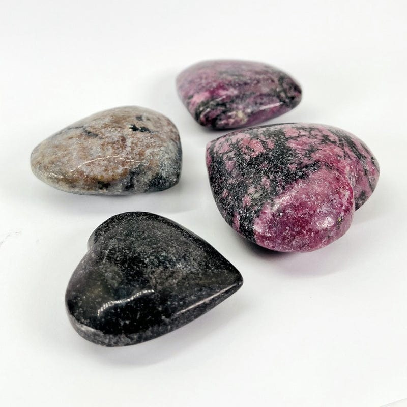 side view of the polished rhodonite hearts showing the thickness 