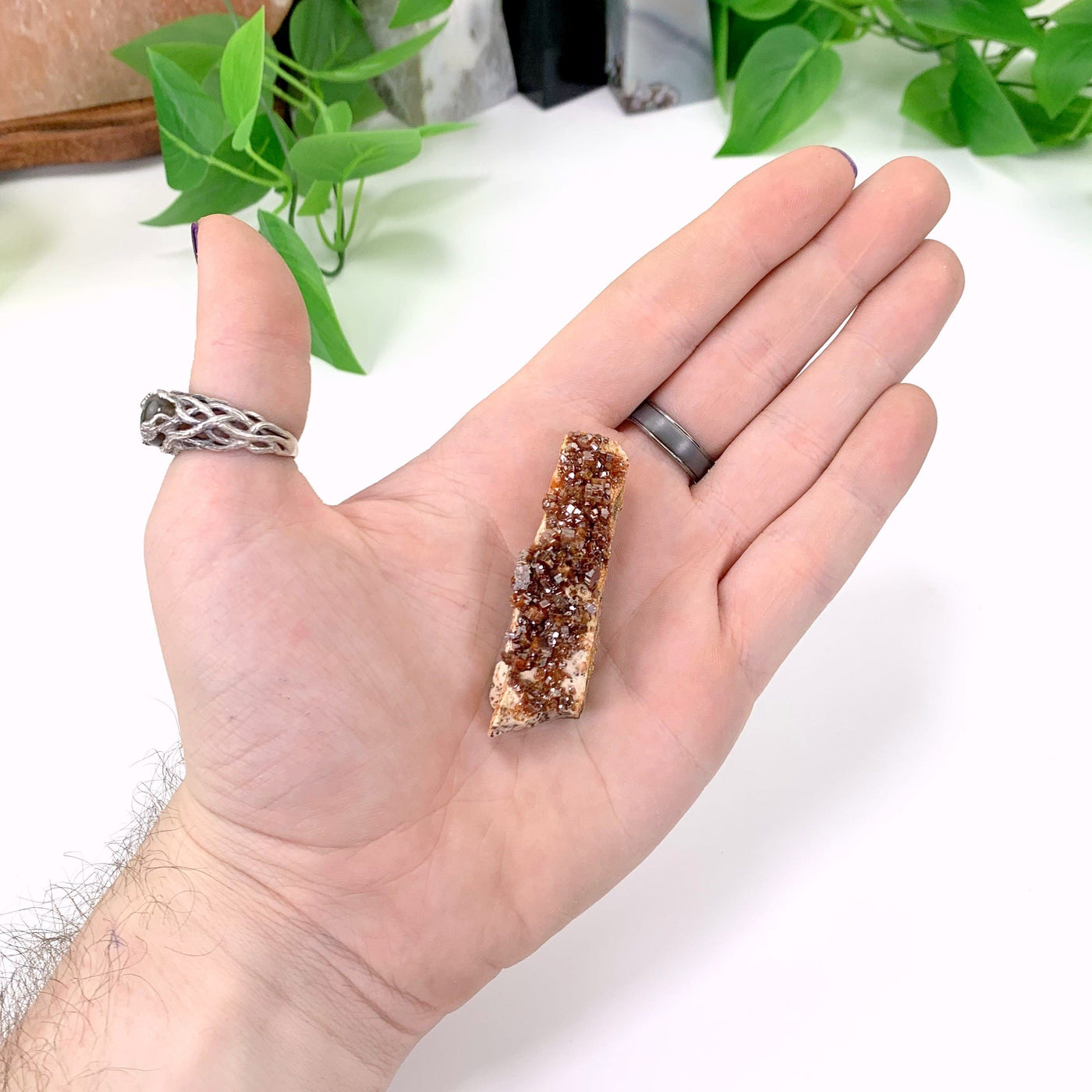 vanadinite cluster in hand with white background