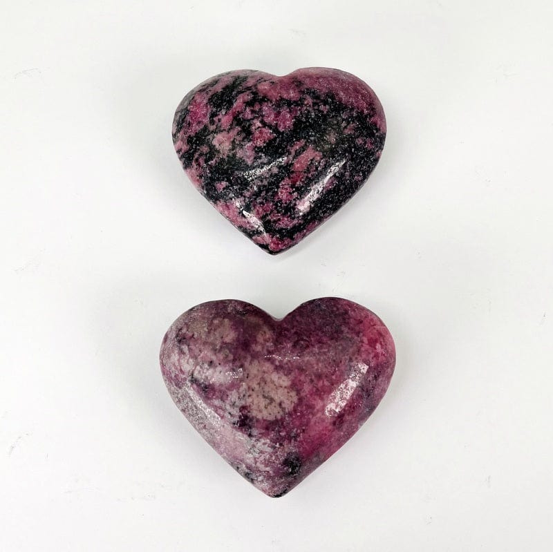 close up of polished rhodonite hearts 