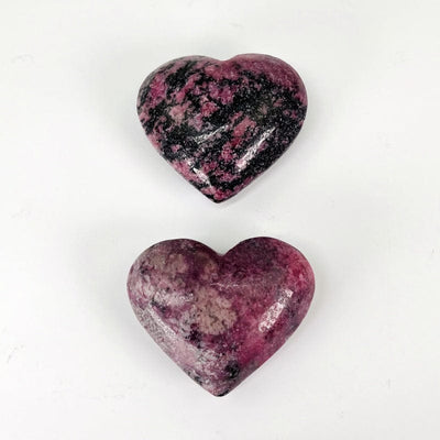 close up of polished rhodonite hearts 