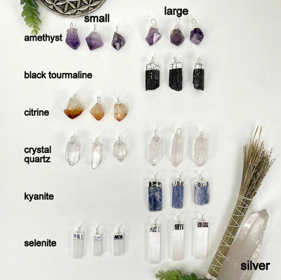 all silver hoop bail pendants on white background with small gemstone point pendants on the left and large gemstone point pendants on the right for size comparison